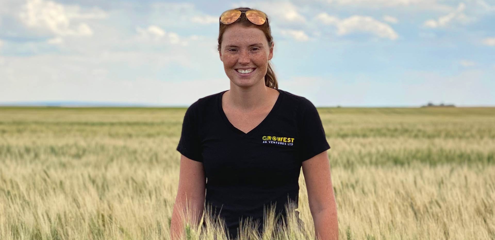 Photo of Shannon Winny of GroWest Ag Ventures in a wheat field