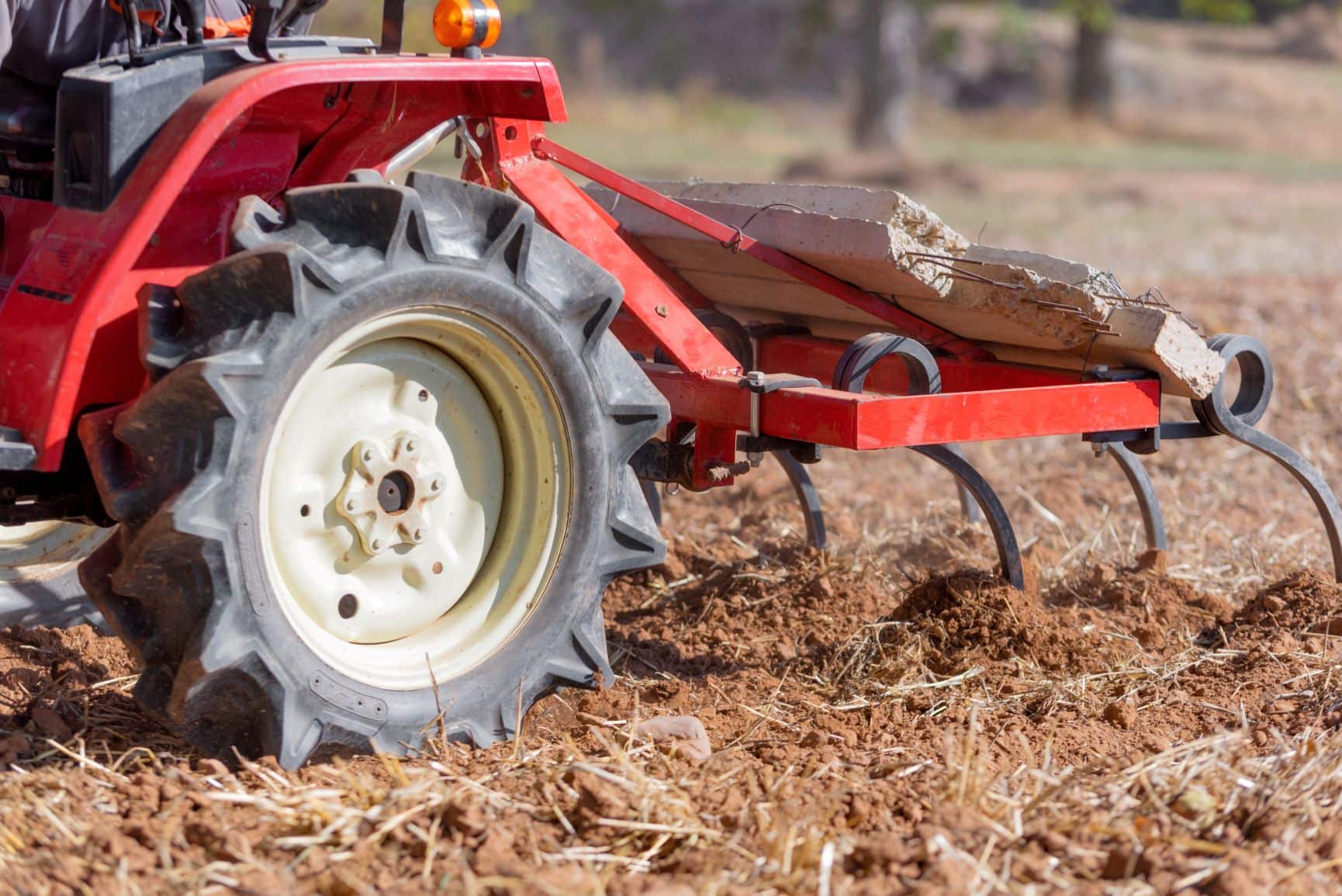 A small plow passing over soil